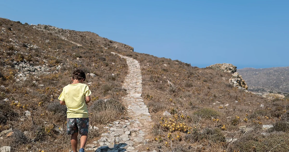 Gabriel walking up the path to the top of the Exomvourgo Mountain, Tinos, Greece